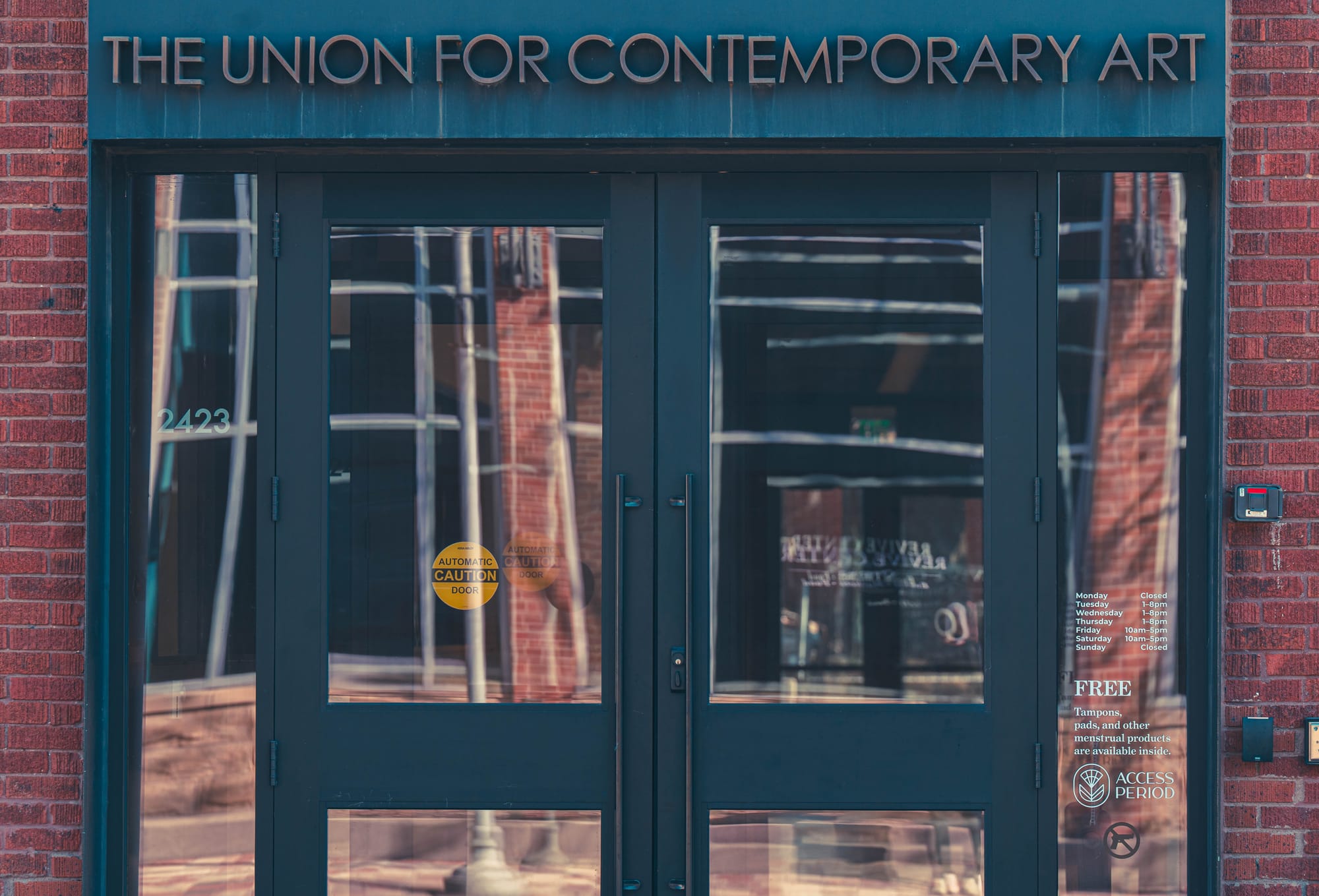 Entryway doors to a brick building. Over top of the glass doors is "The Union for Contemporary Art"